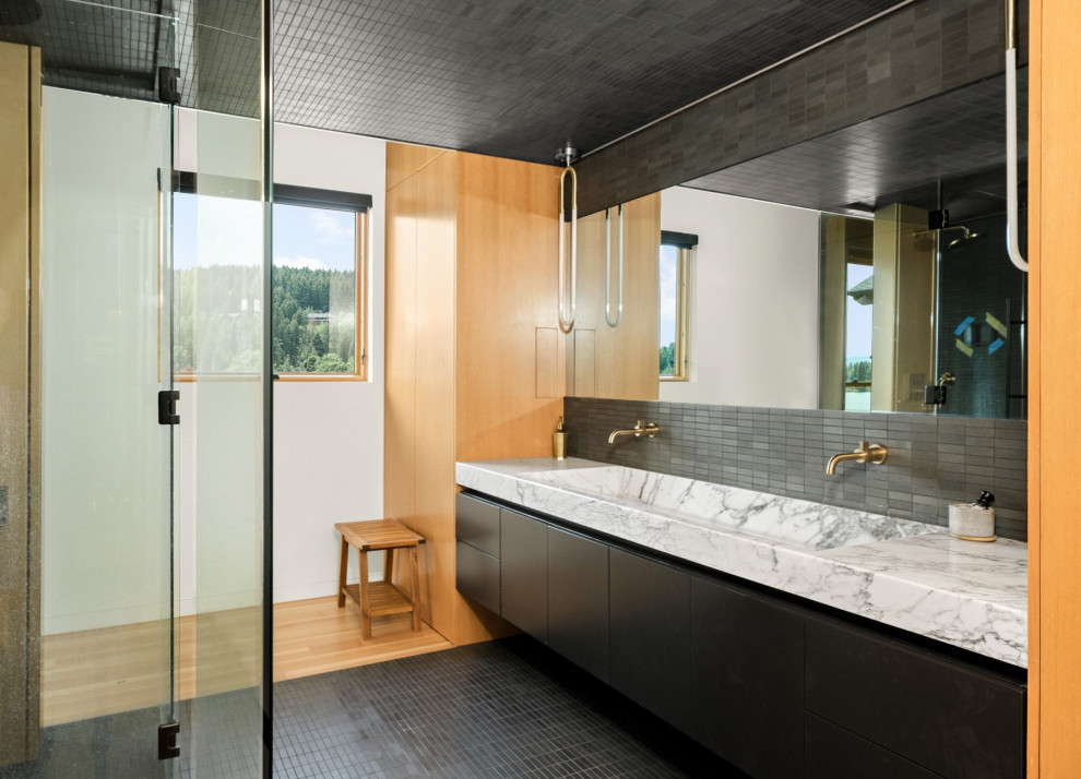 Inspiration for a contemporary master bathroom in Other with flat-panel cabinets, black cabinets, a curbless shower, black tile, mosaic tile floors, a trough sink, marble benchtops, black floor, a hinged shower door, multi-coloured benchtops, a double vanity and a floating vanity.