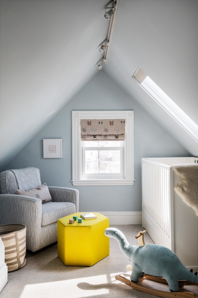 Inspiration for a small classic nursery for boys in Boston with blue walls, carpet, beige floors and a vaulted ceiling.