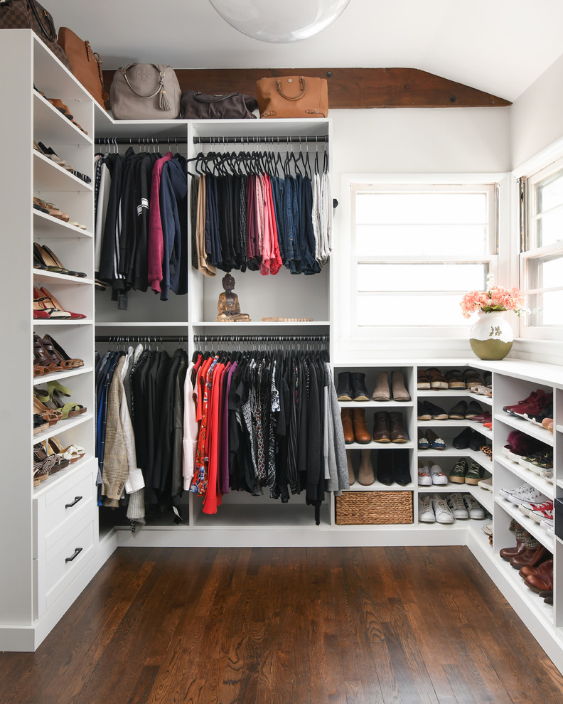 Design ideas for a large modern gender-neutral walk-in wardrobe in New York with white cabinets and brown floor.
