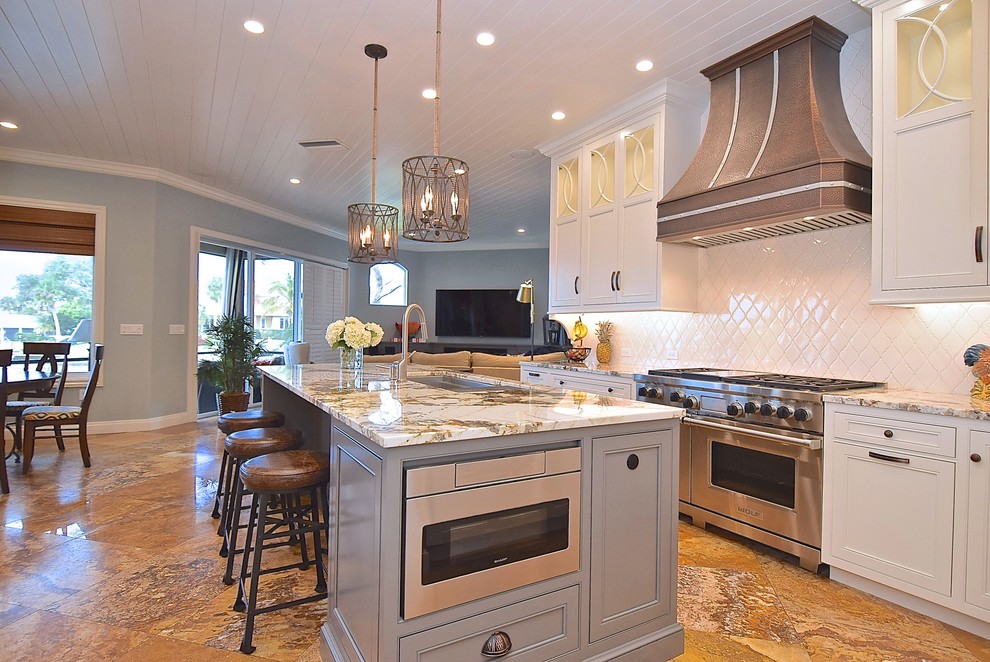 Photo of a large transitional u-shaped open plan kitchen in Tampa with an undermount sink, beaded inset cabinets, white cabinets, quartzite benchtops, white splashback, ceramic splashback, panelled appliances, marble floors and with island.