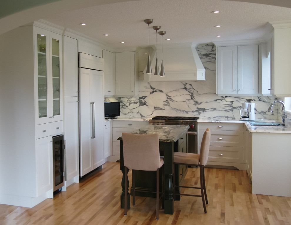 Eat-in kitchen - mid-sized transitional u-shaped light wood floor eat-in kitchen idea in Calgary with an undermount sink, recessed-panel cabinets, stone slab backsplash, paneled appliances, an island, white cabinets, marble countertops and multicolored backsplash