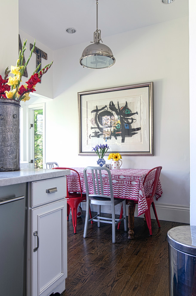 Photo of an eclectic eat-in kitchen in San Francisco with recessed-panel cabinets and white cabinets.