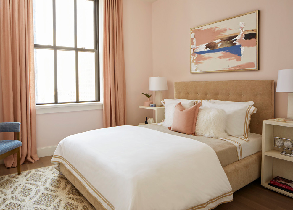 Design ideas for a traditional bedroom in New York with pink walls, medium hardwood floors and brown floor.