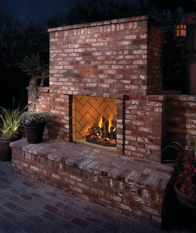 Inspiration for a mid-sized country backyard patio in Albuquerque with a fire feature, brick pavers and no cover.