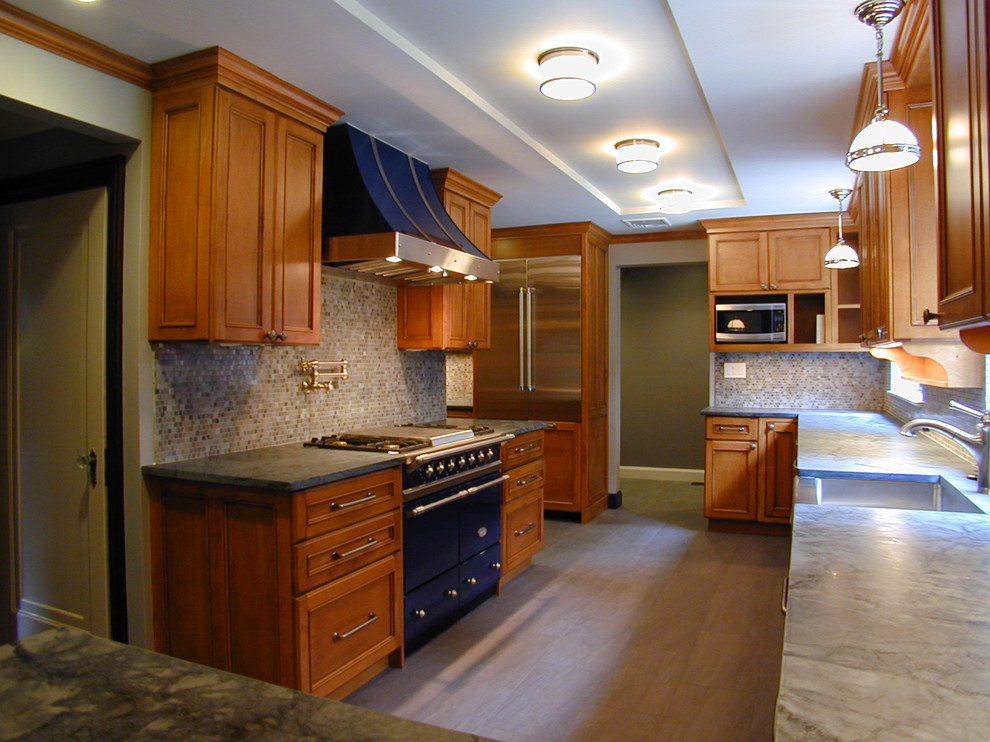 Inspiration for a large transitional u-shaped porcelain tile eat-in kitchen remodel in Boston with a farmhouse sink, recessed-panel cabinets, dark wood cabinets, soapstone countertops, white backsplash, mosaic tile backsplash, stainless steel appliances and an island