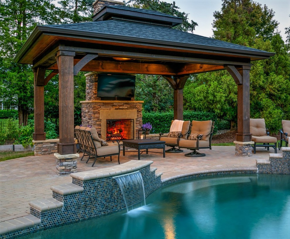 Mid-sized arts and crafts backyard patio in Charlotte with a fire feature, concrete pavers and a gazebo/cabana.
