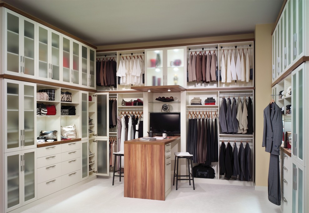 This is an example of a large contemporary gender-neutral walk-in wardrobe in Philadelphia with flat-panel cabinets, white cabinets, carpet and white floor.