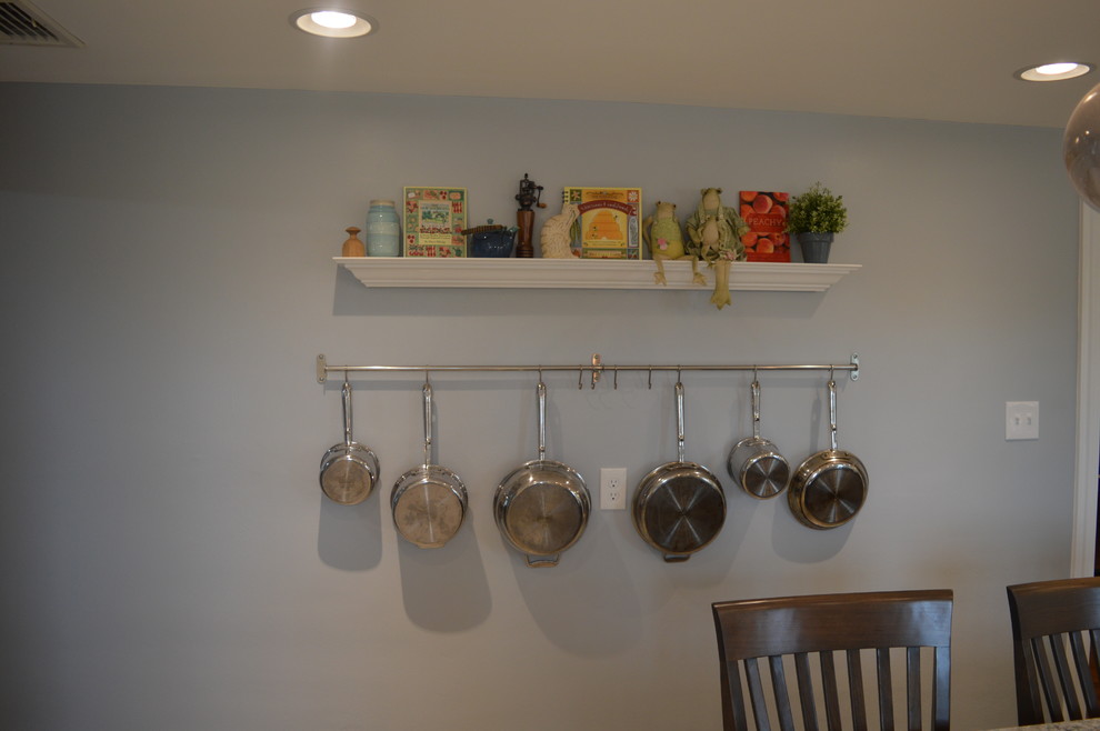 Inspiration for a large transitional u-shaped ceramic tile and gray floor home design remodel with a farmhouse sink, raised-panel cabinets, white cabinets, quartz countertops, gray backsplash, glass tile backsplash, stainless steel appliances and an island