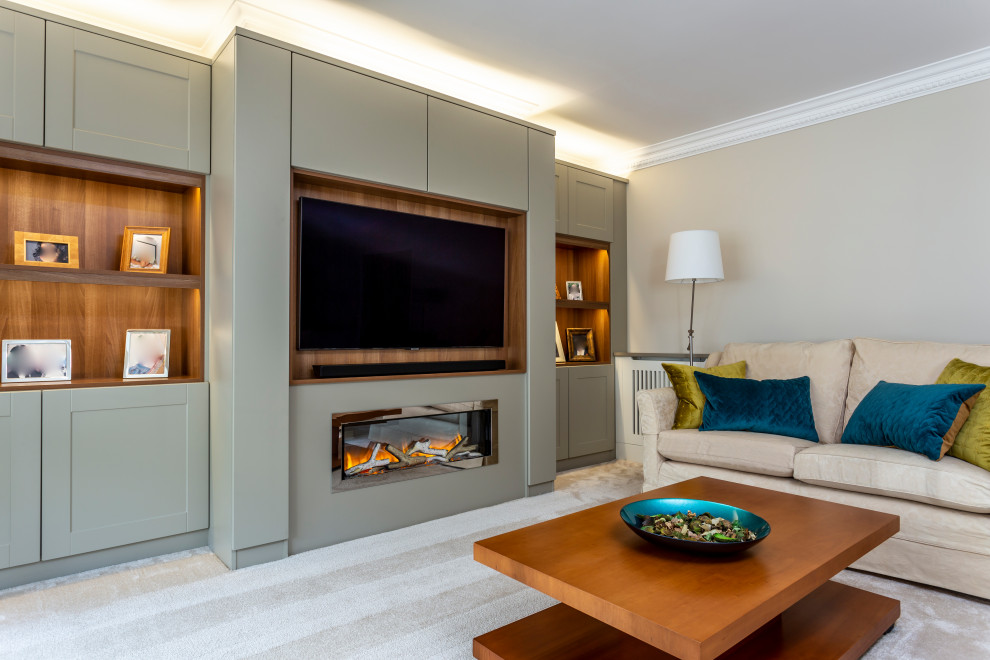 Large modern enclosed living room in Hertfordshire with a music area, grey walls, carpet, a hanging fireplace, a wooden fireplace surround, a built-in media unit and beige floors.