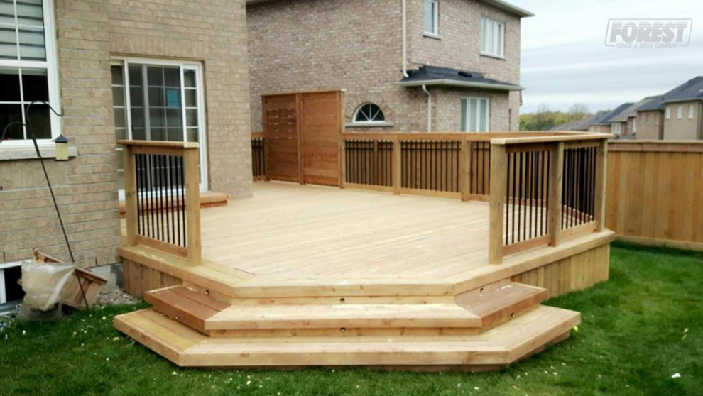 Example of a mid-sized mountain style backyard deck design in Toronto