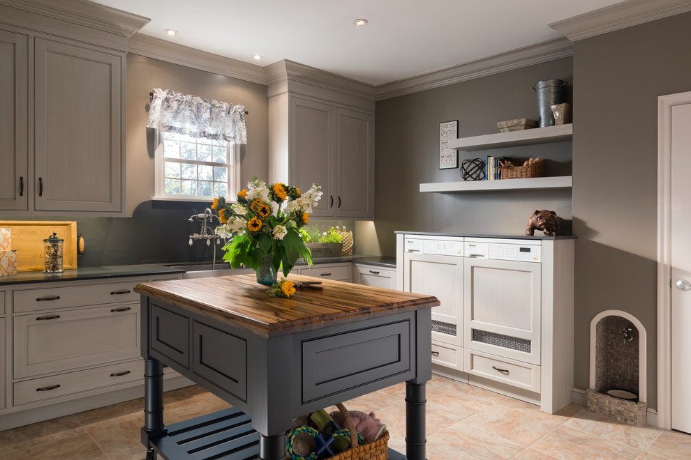 Example of a mid-sized transitional l-shaped travertine floor eat-in kitchen design in Chicago with a farmhouse sink, shaker cabinets, gray cabinets, wood countertops, green backsplash, stone slab backsplash, stainless steel appliances and an island