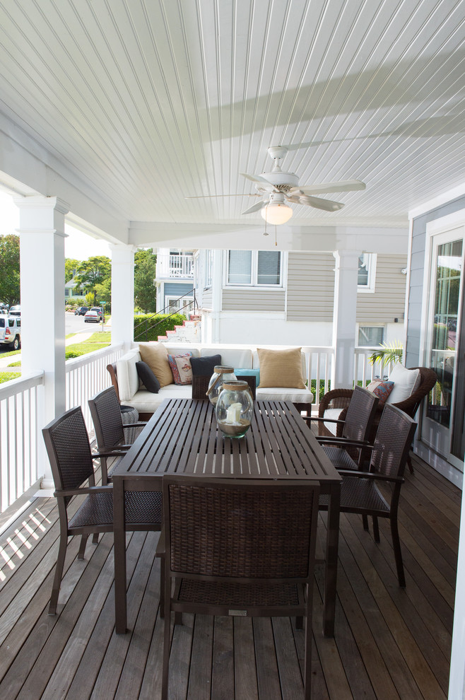This is an example of a large beach style front yard verandah in New York with decking.