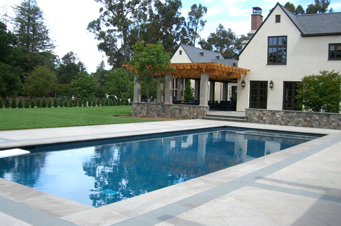 Photo of a modern backyard rectangular aboveground pool in Houston with natural stone pavers.