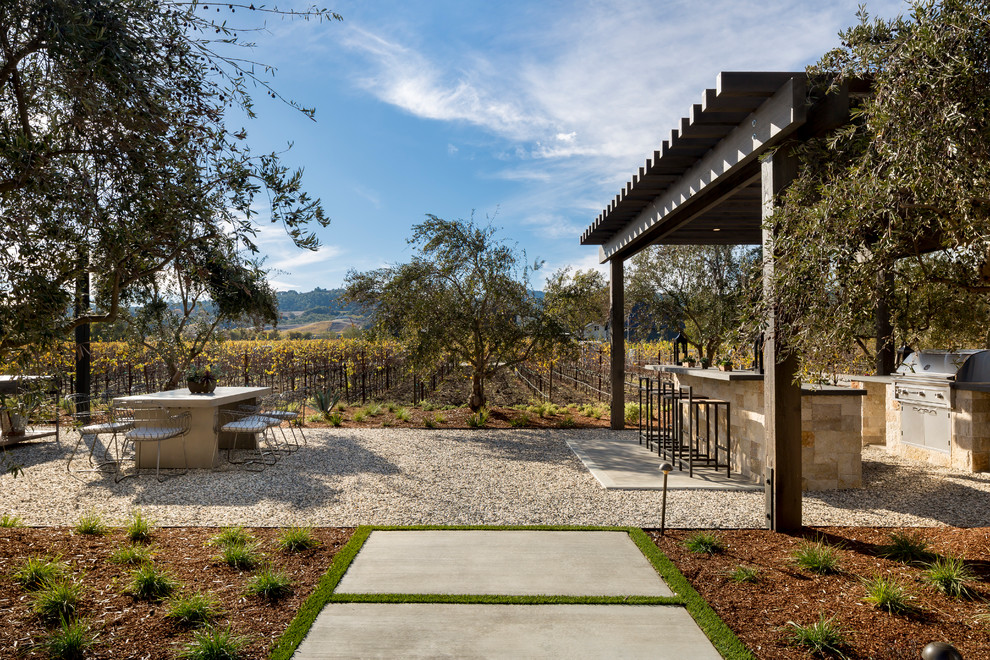 Inspiration for an expansive contemporary backyard patio in San Francisco with an outdoor kitchen, gravel and a pergola.