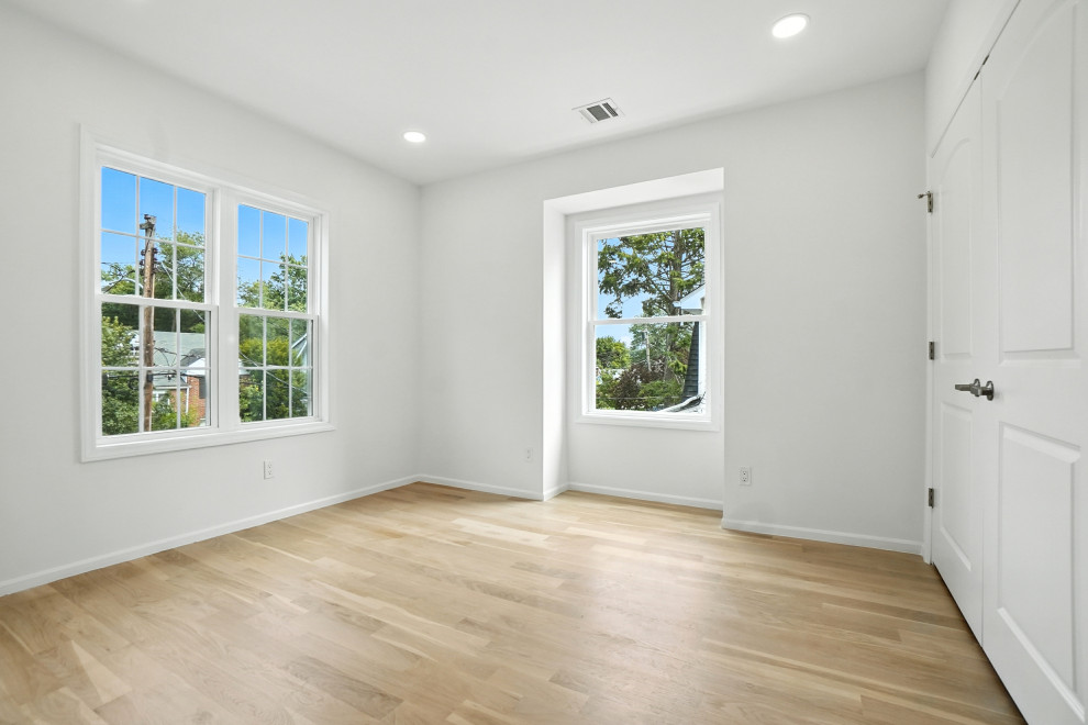 Bright Bedroom with Hardwood and Two Windows