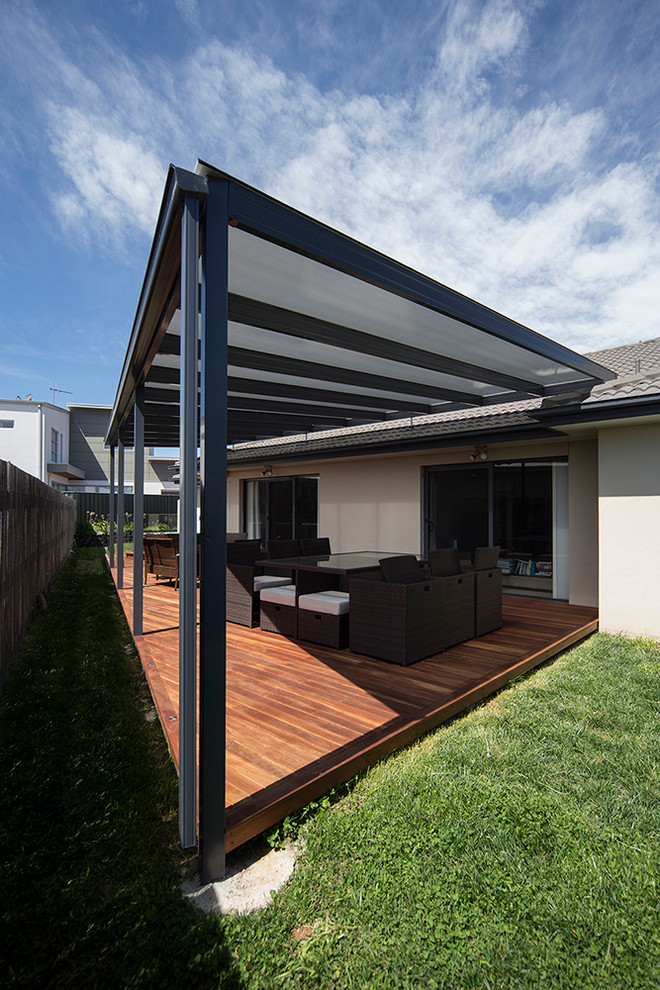 Photo of a large contemporary backyard deck in Canberra - Queanbeyan with a pergola.