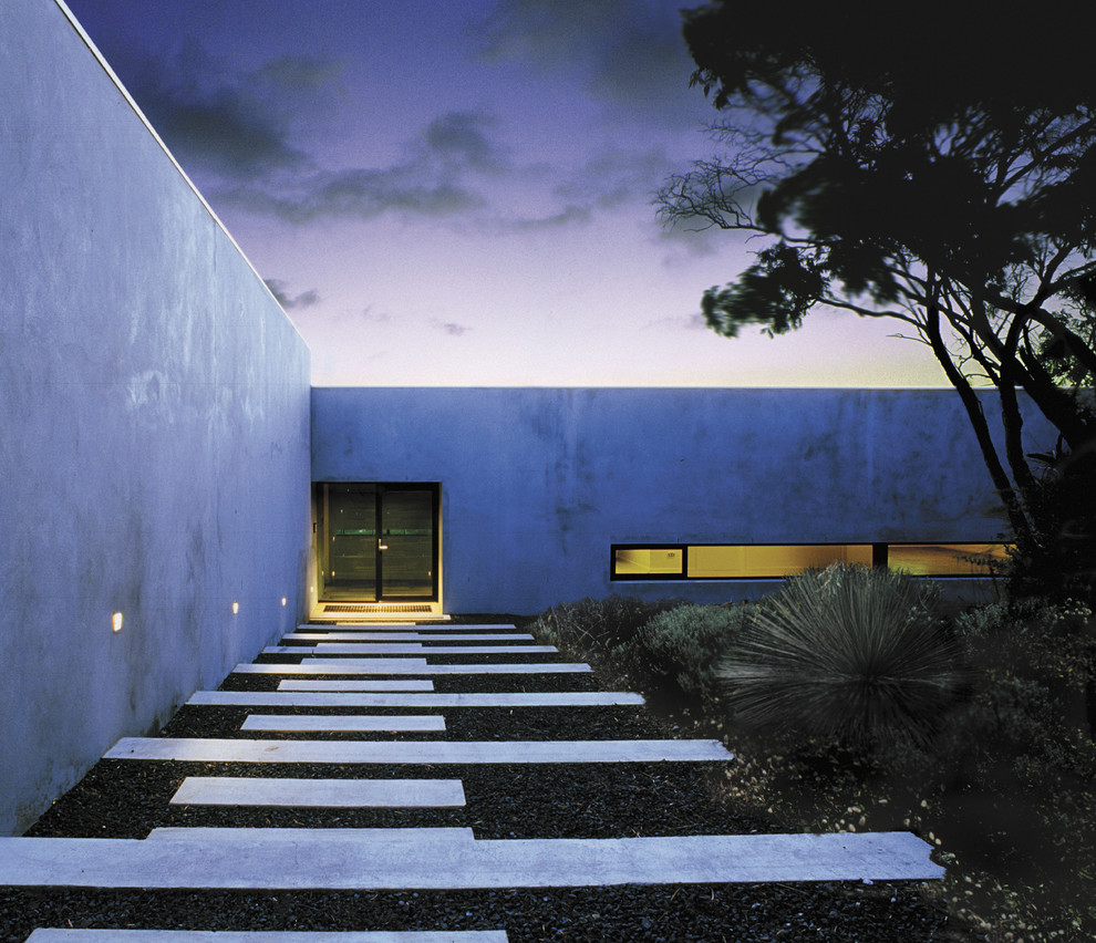 Photo of a large modern front door in Sydney with concrete floors and a single front door.