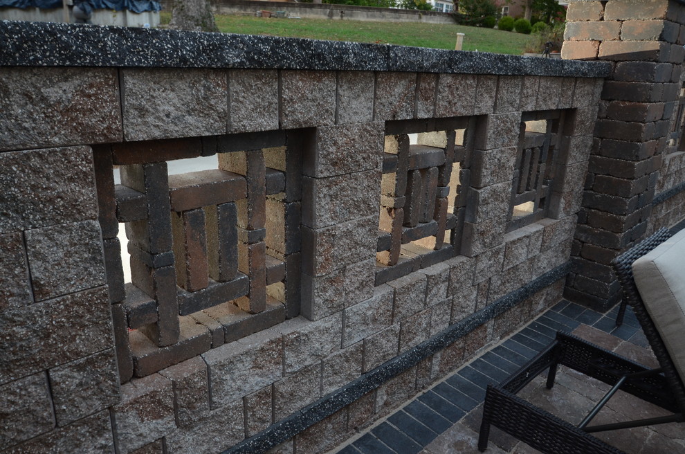 Example of a mountain style backyard concrete paver home design design
