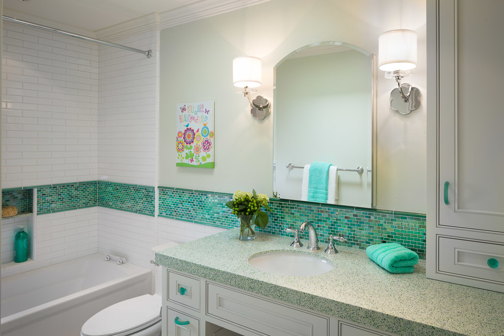 Transitional kids bathroom in San Francisco with an undermount sink, beaded inset cabinets, white cabinets, recycled glass benchtops, green tile, ceramic tile, green walls and porcelain floors.