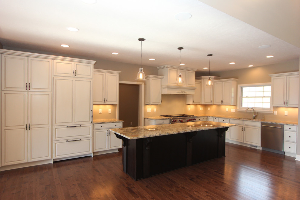 Inspiration for a large transitional l-shaped medium tone wood floor open concept kitchen remodel with a double-bowl sink, raised-panel cabinets, white cabinets, granite countertops, stainless steel appliances and an island