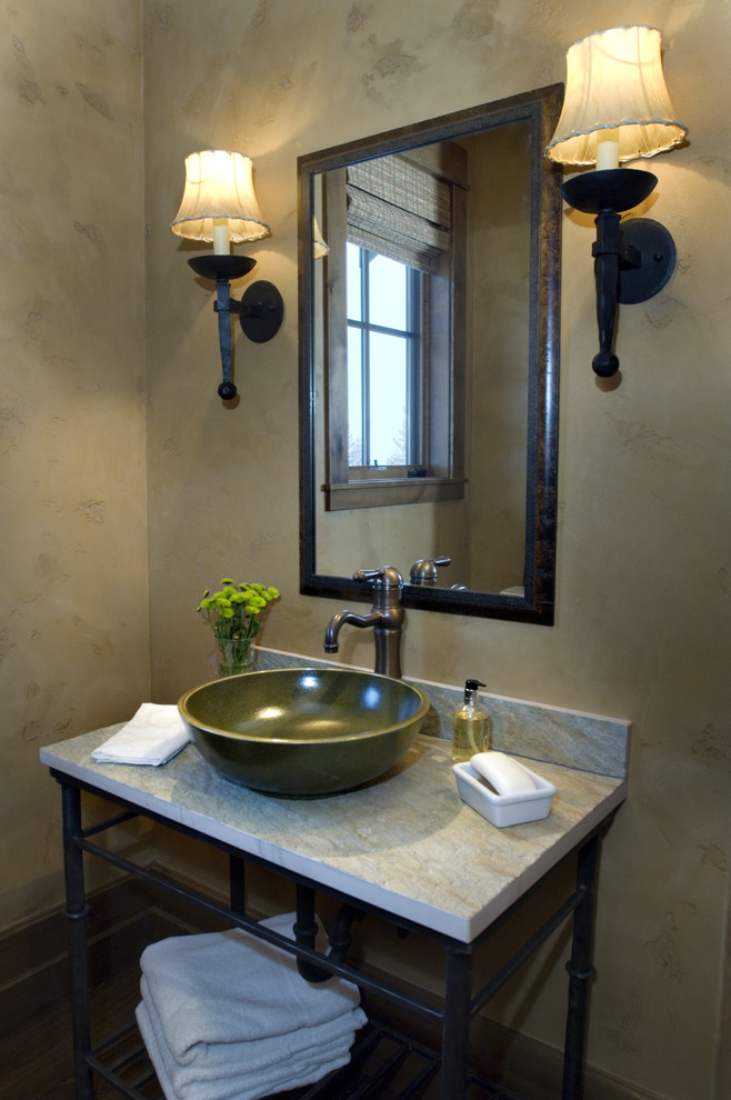 Photo of an industrial powder room in Other with marble benchtops and a vessel sink.