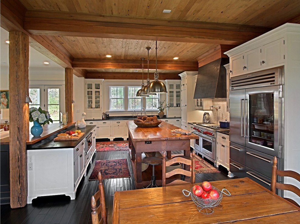 This is an example of a traditional u-shaped eat-in kitchen in Richmond with recessed-panel cabinets, white cabinets and stainless steel appliances.
