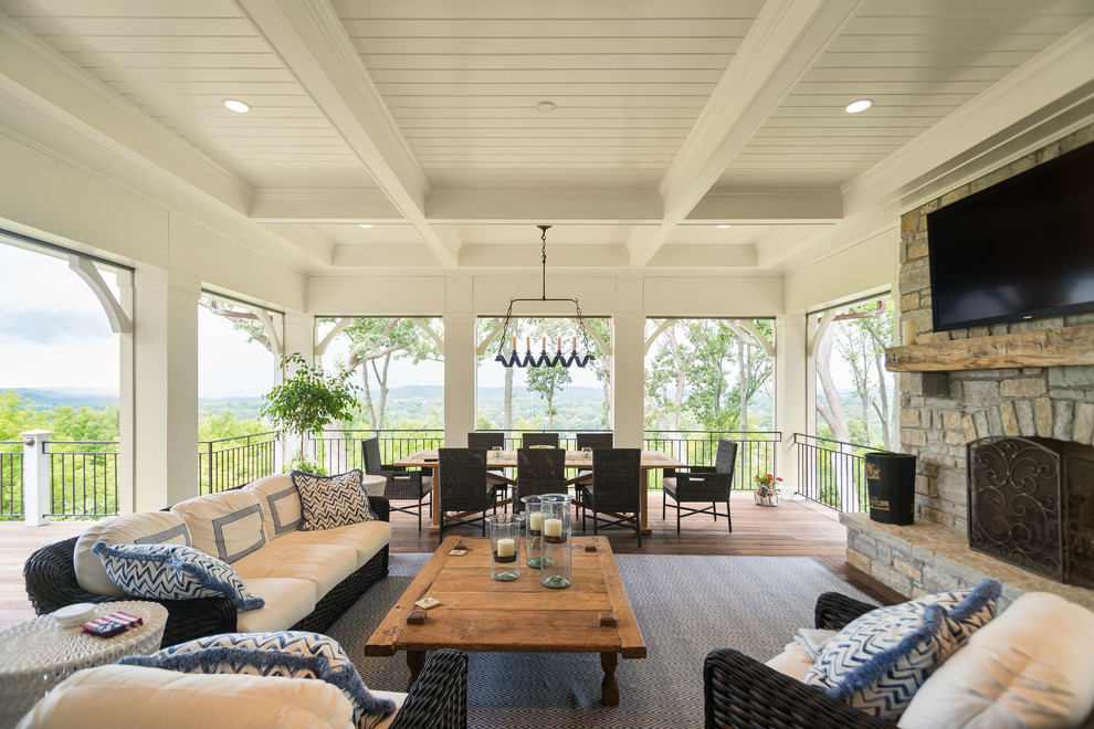 Large elegant backyard deck photo in Cincinnati with a roof extension
