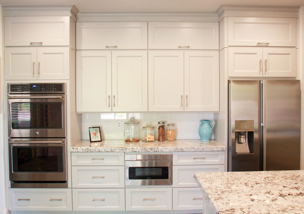 Inspiration for a mid-sized transitional u-shaped porcelain tile and gray floor eat-in kitchen remodel in Phoenix with a double-bowl sink, shaker cabinets, gray cabinets, granite countertops, white backsplash, subway tile backsplash, stainless steel appliances, an island and white countertops