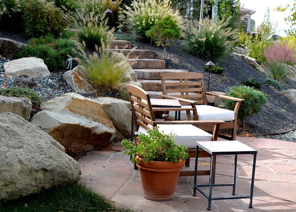 Mid-sized contemporary backyard patio in Boise with natural stone pavers and no cover.