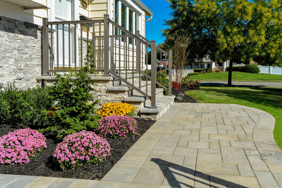 Design ideas for a traditional driveway in New York with a retaining wall.
