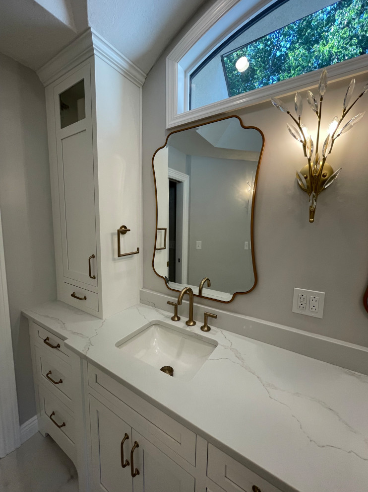 Large classic ensuite bathroom in Other with flat-panel cabinets, white cabinets, a freestanding bath, multi-coloured tiles, porcelain tiles, engineered stone worktops, white worktops, double sinks and a built in vanity unit.