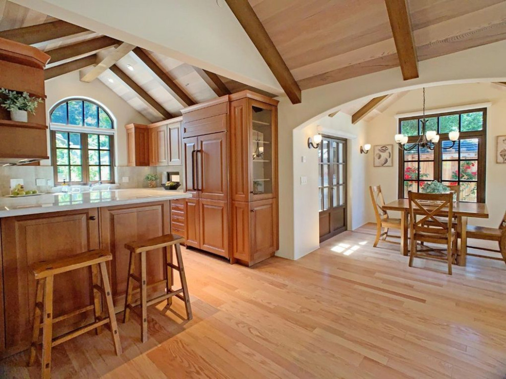Inspiration for a transitional kitchen remodel with an undermount sink, shaker cabinets, light wood cabinets and stainless steel appliances