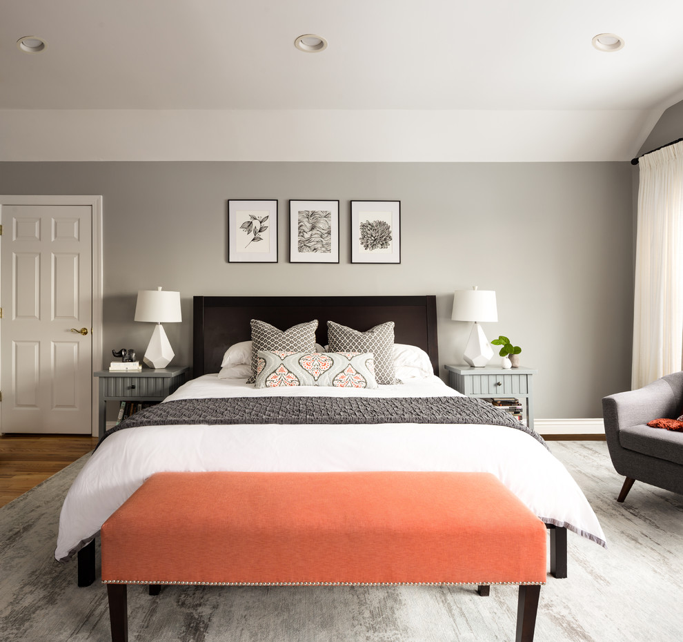 Photo of a large transitional master bedroom in New York with grey walls and dark hardwood floors.