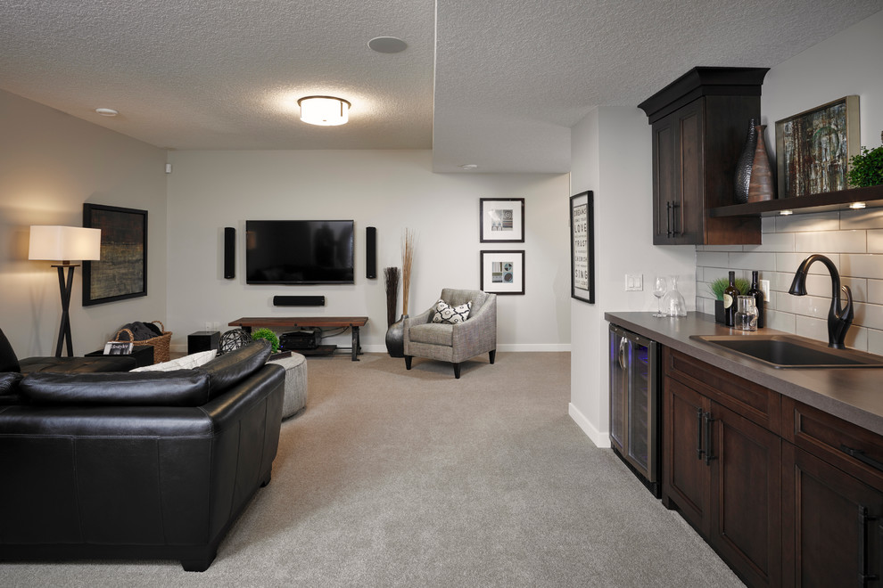 Design ideas for a transitional fully buried basement in Calgary with beige walls, carpet and no fireplace.