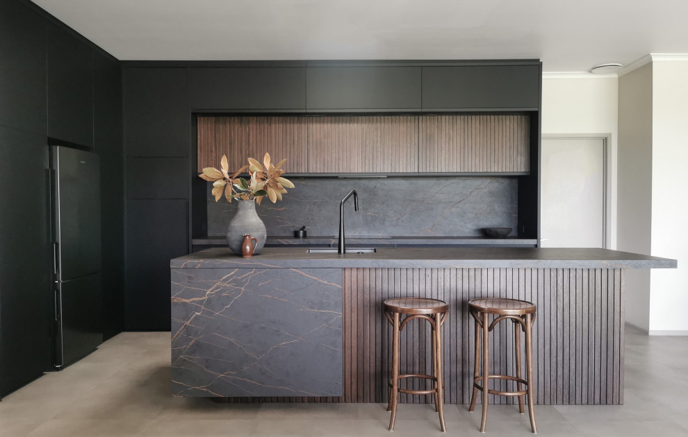 Photo of a modern l-shaped kitchen with an undermount sink, flat-panel cabinets, dark wood cabinets, grey splashback, concrete floors, with island, grey floor and grey benchtop.