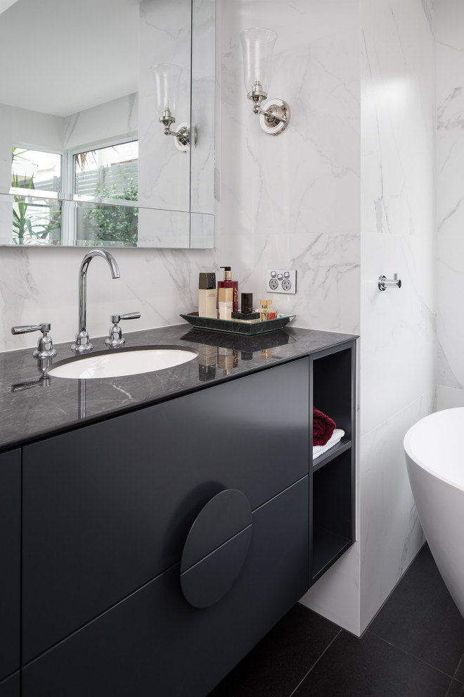 Mid-sized contemporary master bathroom in Perth with black cabinets, a freestanding tub, a one-piece toilet, porcelain tile, an undermount sink, tile benchtops, black floor, black benchtops, a double vanity and a floating vanity.
