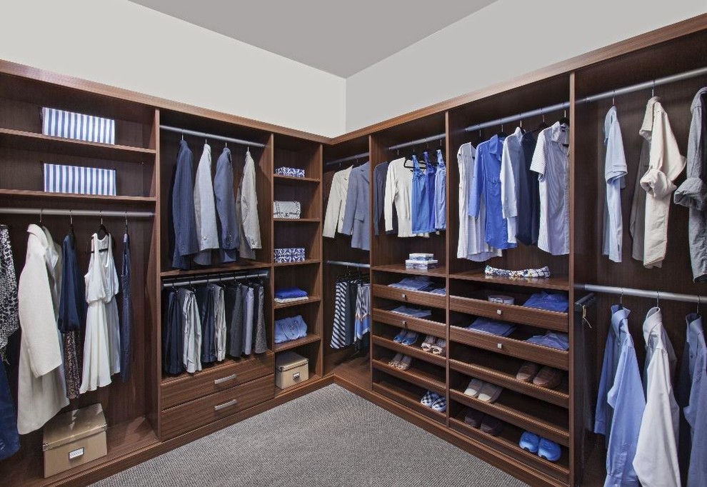 Inspiration for a large transitional men's walk-in wardrobe in Louisville with open cabinets, medium wood cabinets, carpet and grey floor.