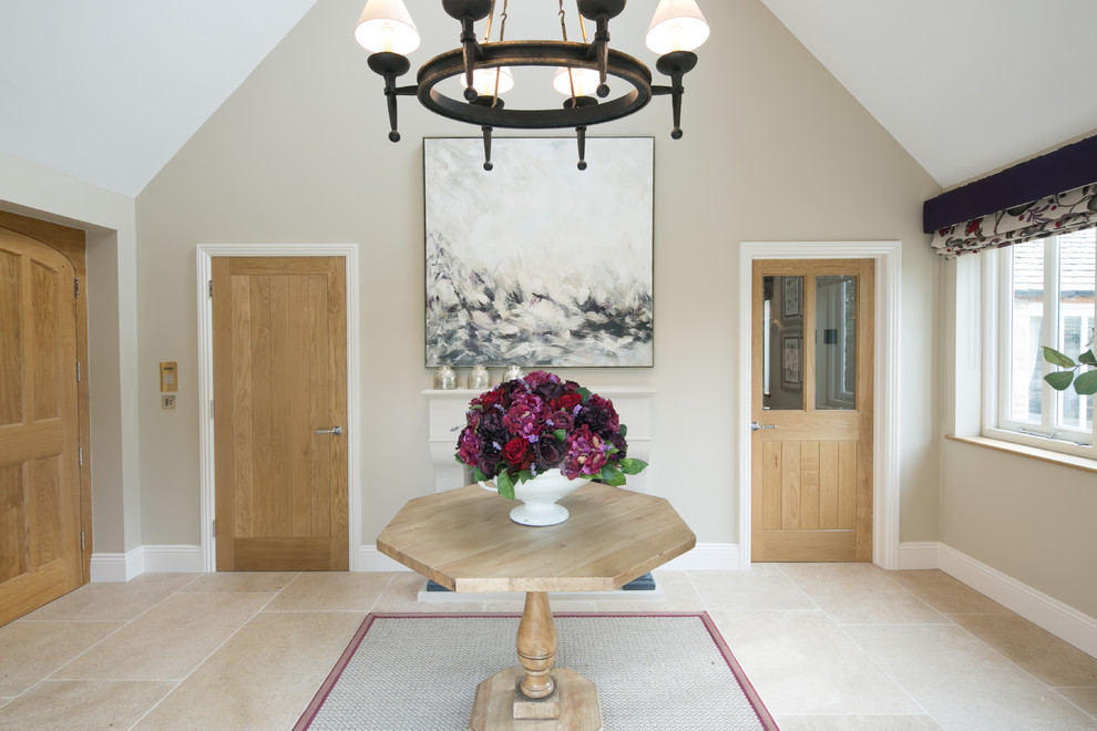 Inspiration for a mid-sized country hallway in Gloucestershire with beige walls and limestone floors.