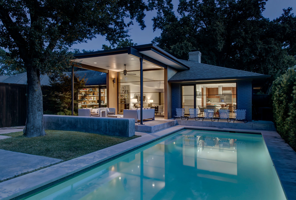 Inspiration for a mid-sized midcentury backyard pool in Dallas with concrete slab.