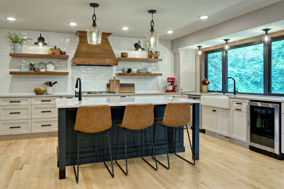 Eat-in kitchen - large transitional u-shaped light wood floor and beige floor eat-in kitchen idea in Minneapolis with a farmhouse sink, shaker cabinets, gray cabinets, quartz countertops, white backsplash, ceramic backsplash, stainless steel appliances, an island and white countertops