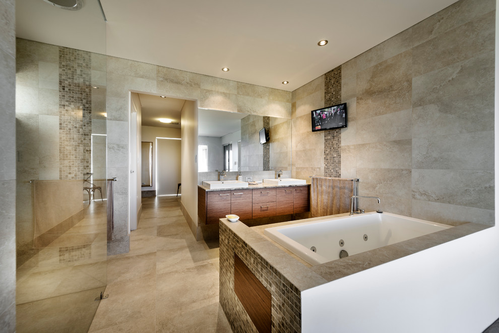 This is an example of a contemporary master bathroom in Perth with a vessel sink, flat-panel cabinets, medium wood cabinets, a drop-in tub, a curbless shower and gray tile.