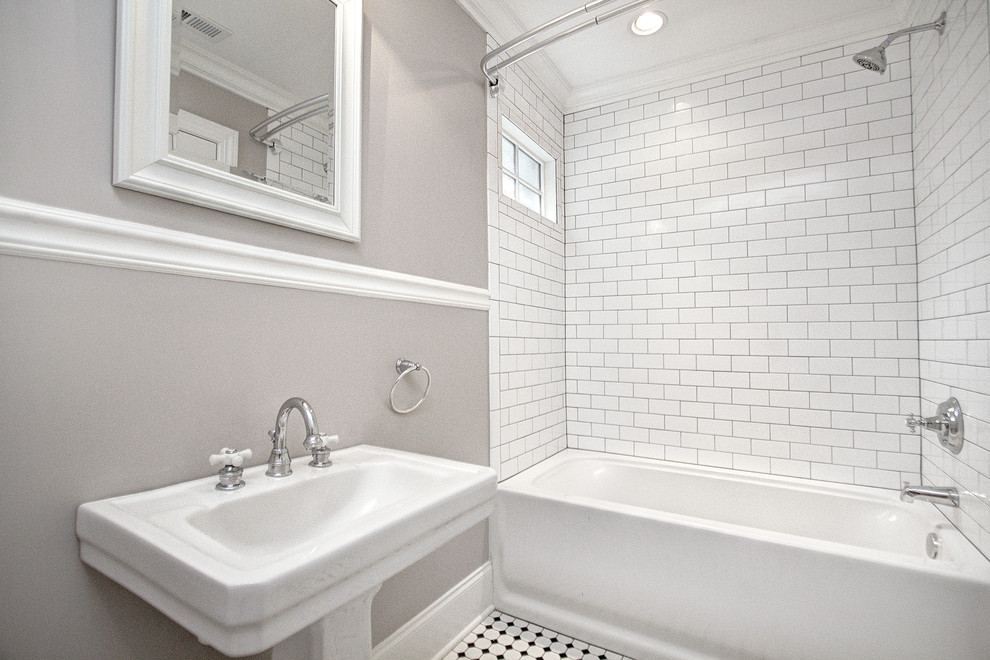 Design ideas for a mid-sized traditional kids bathroom in Charlotte with a drop-in tub, a shower/bathtub combo, a two-piece toilet, white tile, ceramic tile, beige walls, ceramic floors and a pedestal sink.