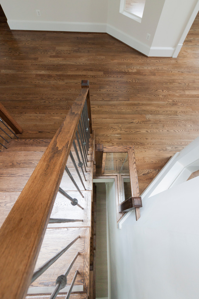Photo of an expansive contemporary wood floating staircase in DC Metro with wood risers and glass railing.