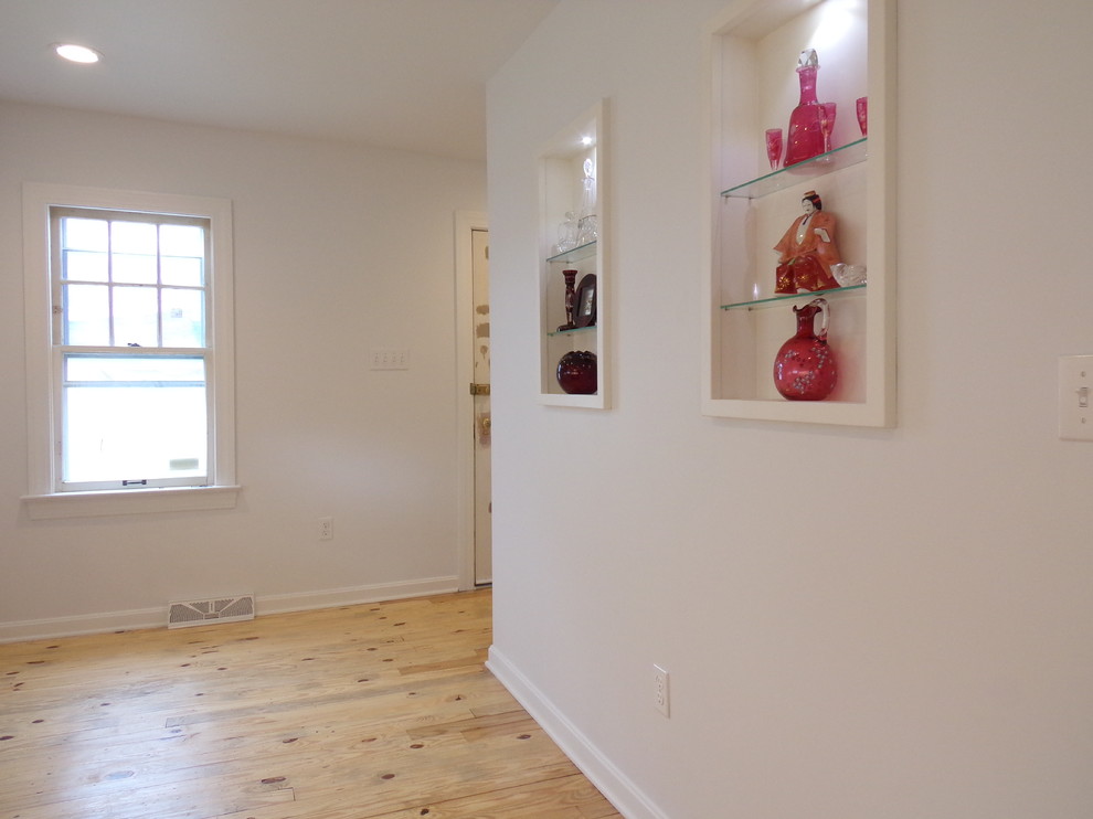 Inspiration for a mid-sized transitional l-shaped plywood floor enclosed kitchen remodel with an undermount sink, shaker cabinets, white cabinets, granite countertops, stainless steel appliances and no island
