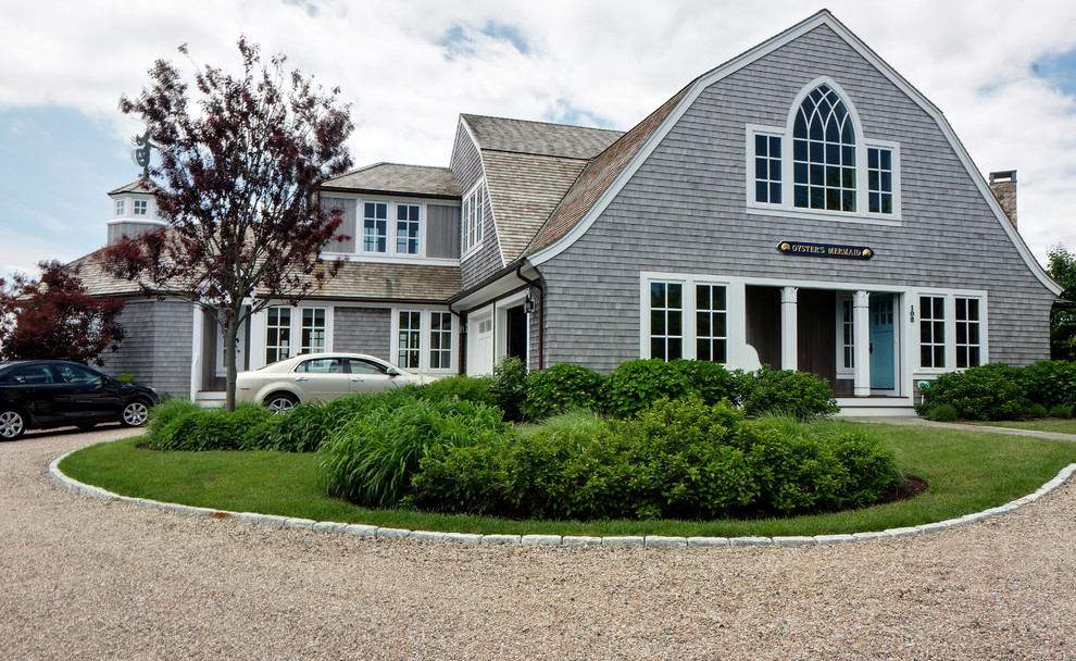 Beach style exterior in Boston with wood siding and a gambrel roof.