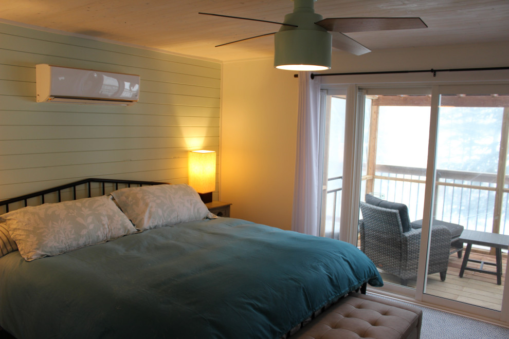 Mid-sized country guest bedroom in Other with white walls, vinyl floors, grey floor, wood and wood walls.