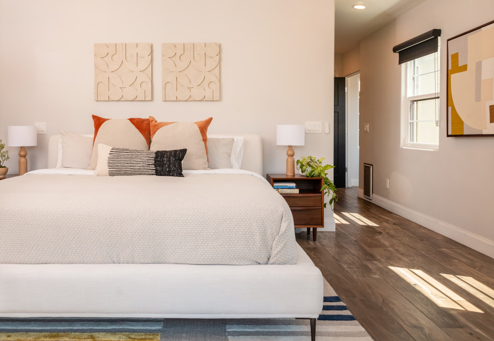 Bedroom - eclectic dark wood floor and brown floor bedroom idea in Phoenix with beige walls