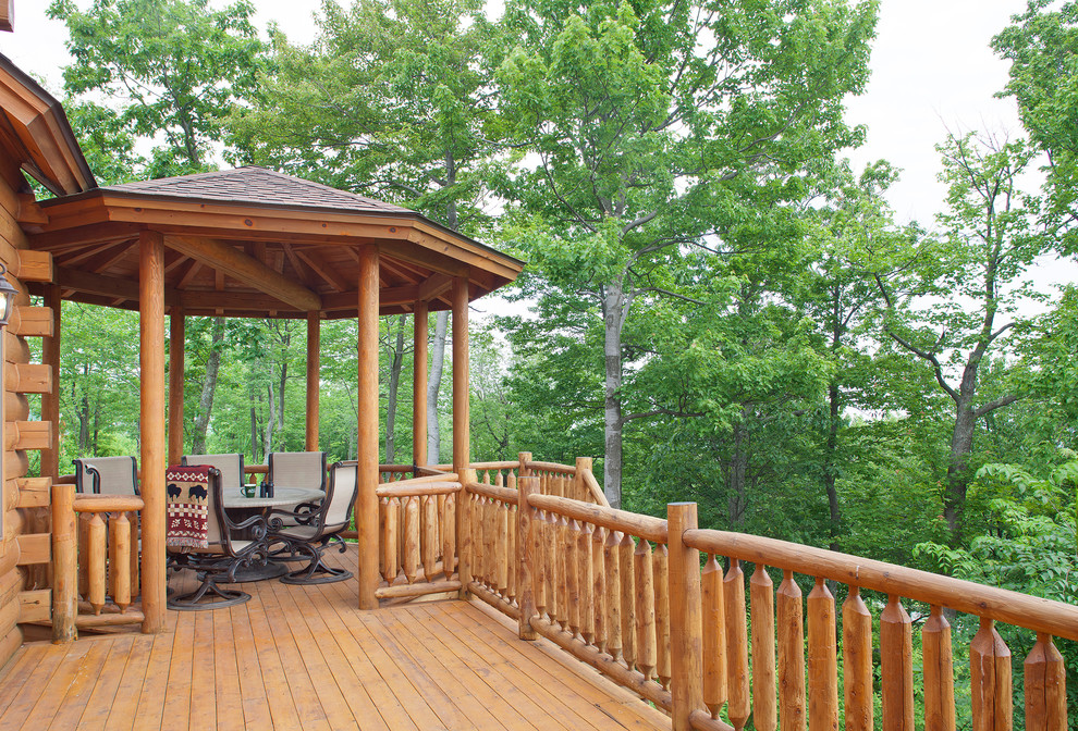 Example of a mid-sized mountain style backyard deck design in DC Metro with a gazebo
