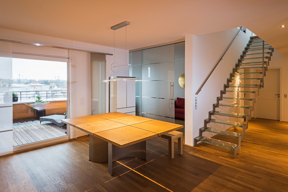 This is an example of a mid-sized contemporary dining room in Munich with medium hardwood floors.