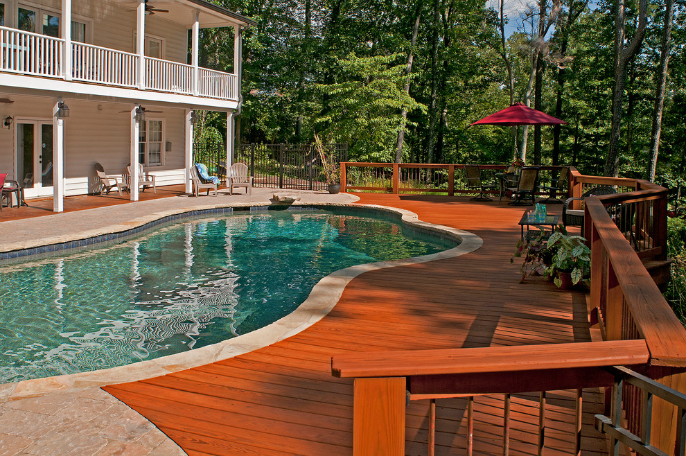 Example of a transitional backyard deck design in Atlanta